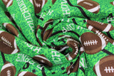 Swirled swatch touchdown fabric (green faux football field look fabric with black yard lines and tossed brown/white cartoon footballs allover and "Touchdown" "Tackle" etc. text in white tossed)