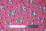 Flat swatch pink unicorns & donuts fabric (bubblegum pink fabric with small white polka dots and tossed cartoon white unicorns with rainbow main and pink bangs/tails, tossed cartoon rainbows with smiling clouds, tossed brown donuts half dipped in pink with sprinkles, tossed stars)