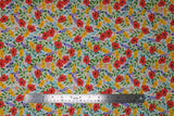 Flat swatch Wildflowers fabric (white fabric with busy tossed wildflowers and greenery allover in red, yellow, orange and blue/purple)