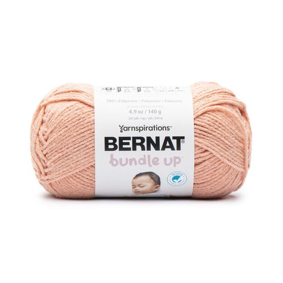 A ball of Bernat Bundle Up yarn in shade Apricot (pale orange)