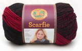 A ball of Lion Brand Scarfie on white background in shade cranberry black (medium red/pink and black colourway)