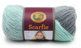 A ball of Lion Brand Scarfie on white background in shade mint silver (pale light blue/green and medium grey colourway)