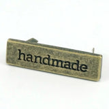 Metal Bag Label: "handmade"