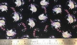 Flat swatch cartoon unicorn head printed fabric in black (black fabric with tossed cartoon white/purple/yellow pastel unicorn heads with pink and purple floral swoopy decoration)