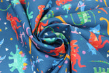 Swirled swatch Tossed Dinos fabric (dark blue fabric with tossed cartoon style dinos allover in various colours with tossed confetti style shapes)