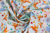Swirled swatch Hatching Dinos fabric (white fabric with hatching orange dinosaurs allover in pastel coloured eggs with confetti shapes)