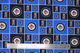 Flat swatch licensed NHL fabric in Winnipeg Jets (quilt squares pattern with blue and navy backgrounds with logo, navy background with team text, blue background with crossing sticks)