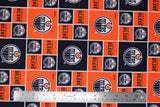 Flat swatch licensed NHL fabric in Edmonton Oilers (quilt squares pattern with orange and navy backgrounds with logo, orange background with team text)