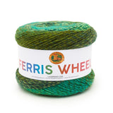 A cake of Lion Brand Ferris Wheel in colourway Evergreen (twisted strands of light, dark, pale, and neon greens)