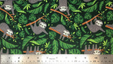 Flat swatch chillin' sloths printed fabric in green (green fabric with tossed greenery and pot leaves, cartoon grey happy sloths with joints in mouth on branches)