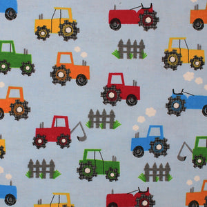 Square swatch tractors fabric (pale light blue fabric with red, orange, green and blue cartoon tractors allover with small white cloud exhaust and grey picket fence sections)