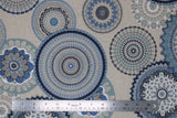 Flat swatch upholstery fabric (blue mandalas print: assorted circular mandala shapes in light to dark blues on beige fabric)