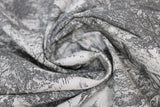 Swirled swatch upholstery fabric (woods print: light grey/beige fabric with dark grey woods scene sketch trees and water)