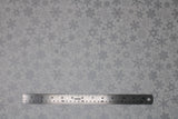 Flat swatch silver fabric (white fabric with tossed silver sparkle effect snowflakes allover)
