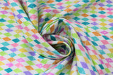 Swirled swatch Easter Harlequin fabric (white fabric with diamond harlequin print in pastel rainbow colours allover)