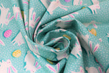 Swirled swatch Busy Bunny fabric (teal blue fabric with white polka dots and tossed white bunnies and colourful easter eggs)