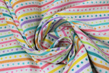 Swirled swatch Dots & Stripes fabric (white fabric with rainbow coloured dots and stripes in horizontal alternating stripes)