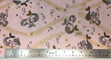 Flat swatch happy mermaid printed fabric in pink (pale pink fabric with doodled smiling mermaids tossed with doodled bubbles, pink, gold and black stars, gold swoopy kelp like background)