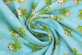 Swirled swatch frogs fabric (light blue/green fabric with tossed green cartoon smiling frogs allover and white small bubbles)