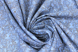 Swirled swatch accent on flowers printed fabric (medium blue fabric with busy floral and butterflies collage print in similar blues)