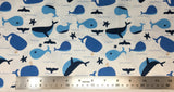 Flat swatch cartoon whales fabric in white (white fabric with tossed blue cartoon whales and waves, tails, starfish, etc.)