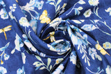 Swirled swatch Dark Blue Toss fabric (dark blue fabric with tossed white and light blue floral clusters and yellow insects)