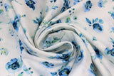Swirled swatch White Toss fabric (white fabric with tossed blue floral heads and clusters with greenery)