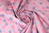 Swirled swatch daisy printed fabric in pink (pink and blue daisies on light pink)