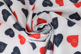 Swirled swatch doctor themed printed fabric in tossed heartbeat (red and black hearts with hearbeat lines on white)