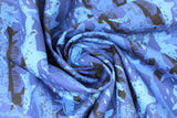 Swirled swatch shark printed fabric in shark camo (black and blue coloured sharks in camo pattern on blue)
