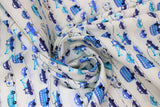 Swirled swatch Handworks Home: Transportation fabric (white fabric with thin dotted black lines/stripes comprising a "road" with assorted blue illustrative style vehicles allover in various styles/shades of blue)