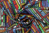 Swirled swatch black fabric (black fabric with multi directional busy collaged text allover in various colours of the rainbow all related to expressing gratitude for healthcare workers "Nurses Rock!" "Thank you" etc.)