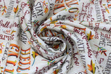 Swirled swatch Celebrate Autumn fabric (white/neutral coloured fabric with fall themed text in various styles/colours allover "Hello Fall" "fall is here" etc.)
