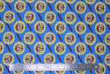 Flat swatch Dr. Strange marvel kawaii printed fabric (Dr. in badge yellow badge with small red text on blue)