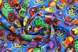 Swirled swatch Marvel Hero Stickers fabric (blue fabric with tossed marvel themed badges allover: character heads, character symbols, etc.)