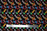 Flat swatch Hero Toss fabric (black fabric with tossed full colour character names and heads tossed allover)