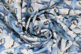 Swirled swatch woodland themed fabric in stacked wolves (white/blue/grey drawn wolf heads collage yellow eyes)