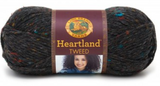 Ball of Lion Brand Heartland in colourway Black Canyon Tweed (heathered black with bright blue, red, orange, and gold flecks)