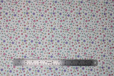 Flat swatch stars fabric (white fabric with tossed pink, purple, blue, green, yellow, red stars in varying sizes and swoopy thin blue vein style lines in background)