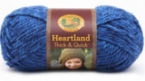 A ball of Lion Brand Heartland Thick & Quick in colourway Olympic (heathered royal blue)