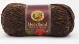 A ball of Lion Brand Heartland Thick & Quick in colourway Sequoia (heathered rich brown)