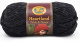 A ball of Lion Brand Heartland Thick & Quick in colourway Black Canyon (heathered black)