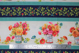 Flat swatch flower bucket stripe fabric (thick white stripes with evenly spaced floral arrangements in buckets in pink, red, orange, and blue flowers with greenery. Alternating is a medium width navy stripe with green floral and red and blue berries. These two stripes are repeated through out and each stripe is separated with a thin aqua stripe with tiny white polka dots)