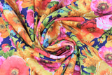Swirled swatch chintz fabric (navy blue with heavy tossed floral heads and greenery in yellow, orange, red, pink, blue flowers)