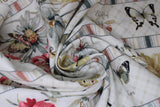 Swirled swatch Insect Stripe fabric (white fabric with stripes of insects with labels: butterfly, moth, dragonfly and thick stripes of red, yellow and white pale coloured floral, all separated by pale multi-coloured thin stripes)