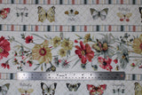 Flat swatch Insect Stripe fabric (white fabric with stripes of insects with labels: butterfly, moth, dragonfly and thick stripes of red, yellow and white pale coloured floral, all separated by pale multi-coloured thin stripes)