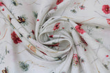 Swirled swatch Tossed Flowers fabric (white fabric with loosely tossed white, red and yellow pale coloured floral with long stems and occasional butterfly on flower)