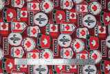 Flat swatch Canadian signs red fabric (red fabric with tossed collaged Canadian badges and signs in white, red, black, grey with "Canada", flags, Highway 1, etc.)