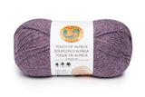 A ball of Lion Brand Touch of Alpaca yarn in purple aster shade on white background (pale medium purple)