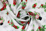 Swirled swatch Stockings fabric (white fabric with tossed red christmas stockings with green accents filled with presents, snowmen, etc. and tossed white snowflakes)